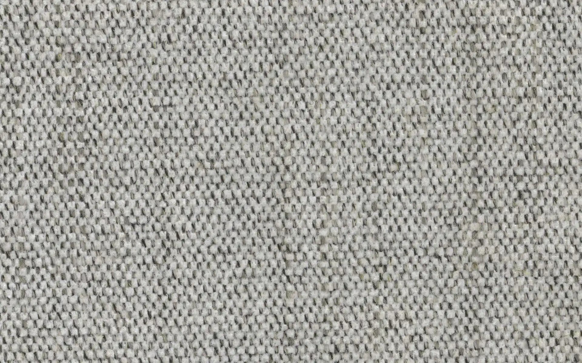 Close-up of soft, textured fabric with a woven pattern in light gray and off-white tones.