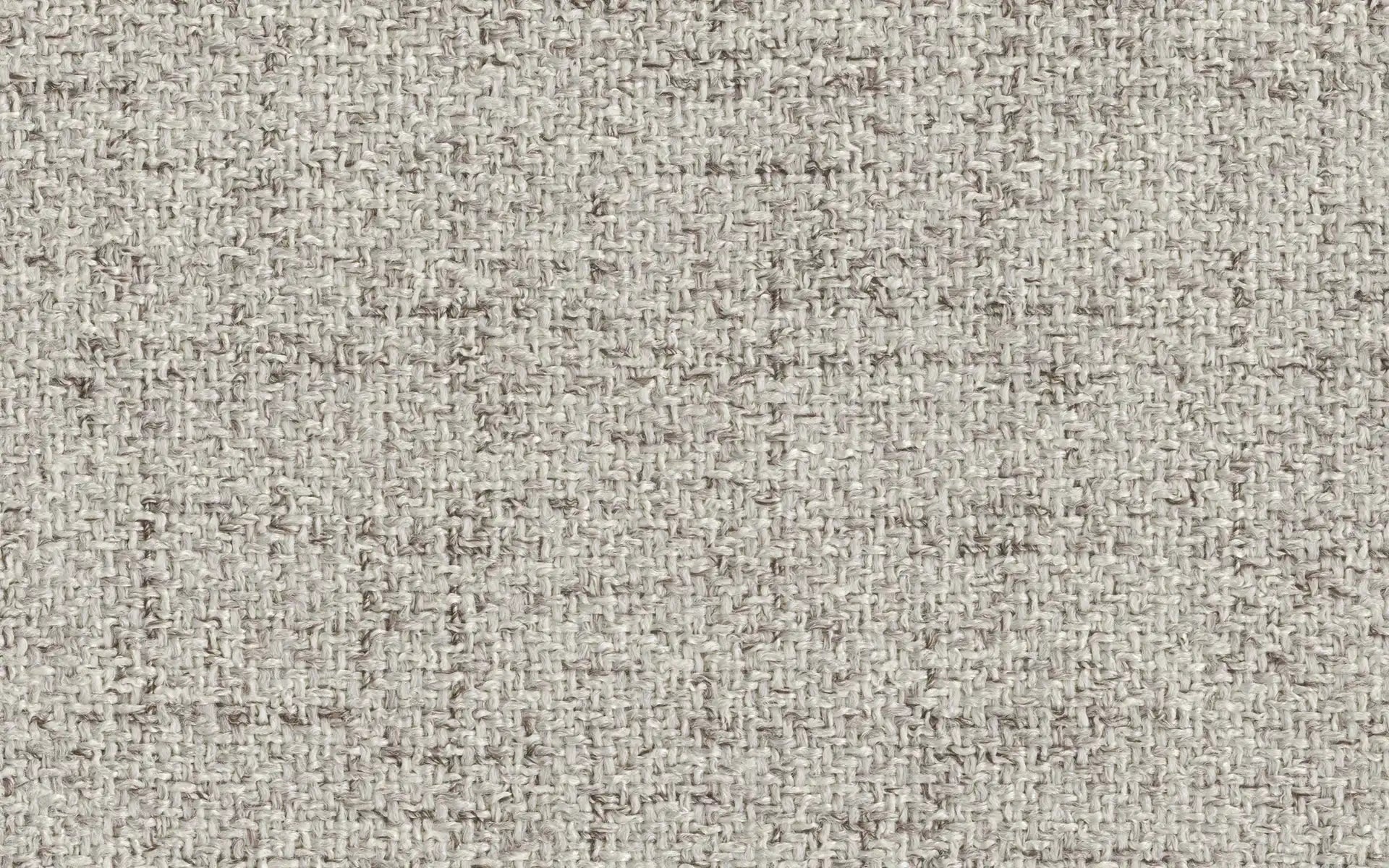 Close-up of beige and light brown woven fabric texture with natural fibers and a rough, rustic appearance.