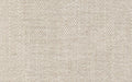 Close-up of beige woven fabric with a soft texture and tightly knit threads, suitable for upholstery or clothing.
