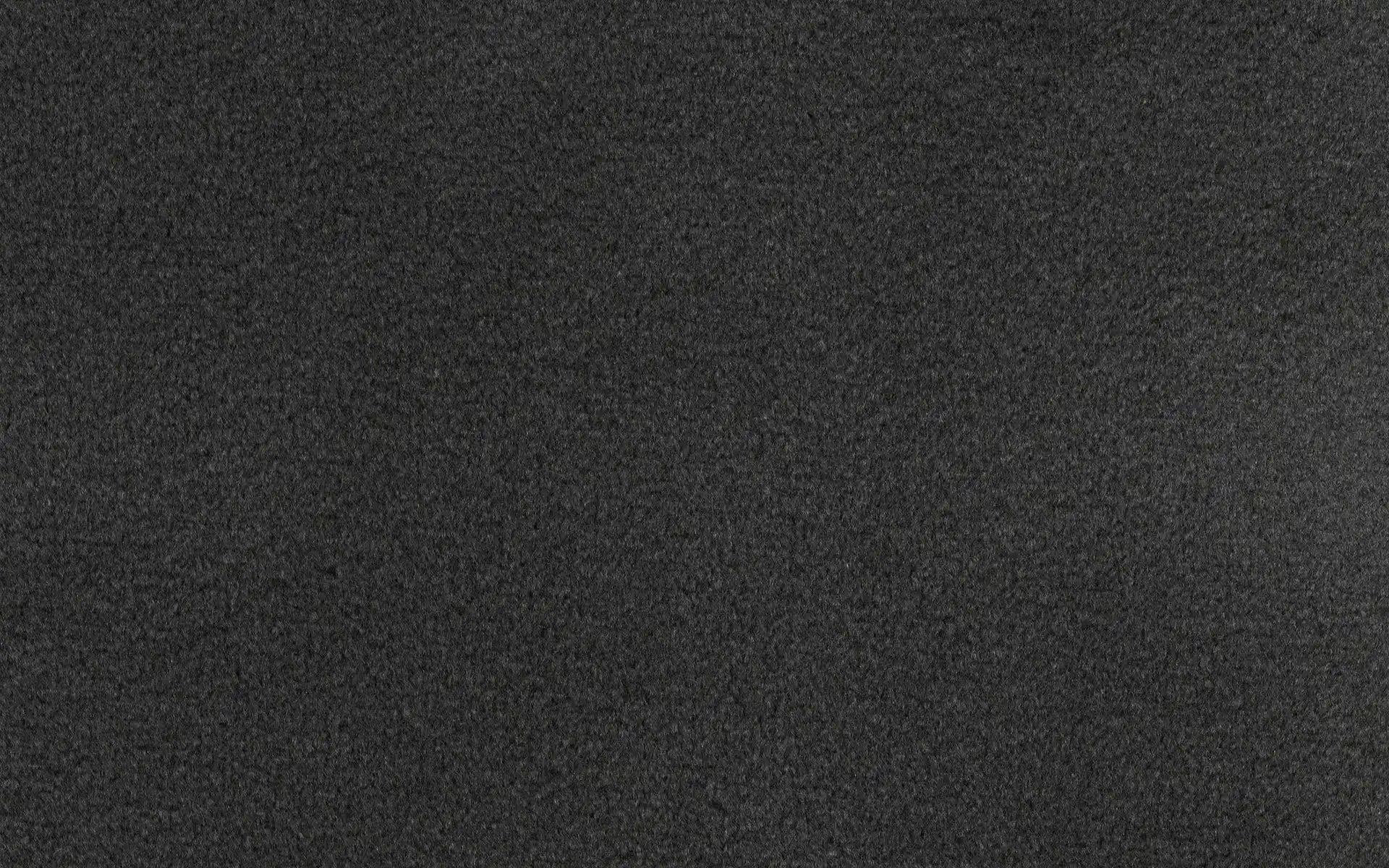 Black textured surface with a rough, granulated appearance, resembling sandpaper or fine gravel material.