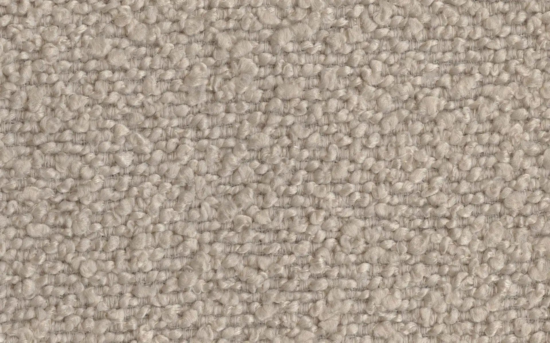 Close-up of soft, beige textured loop pile carpet fibers forming a uniform, plush surface.