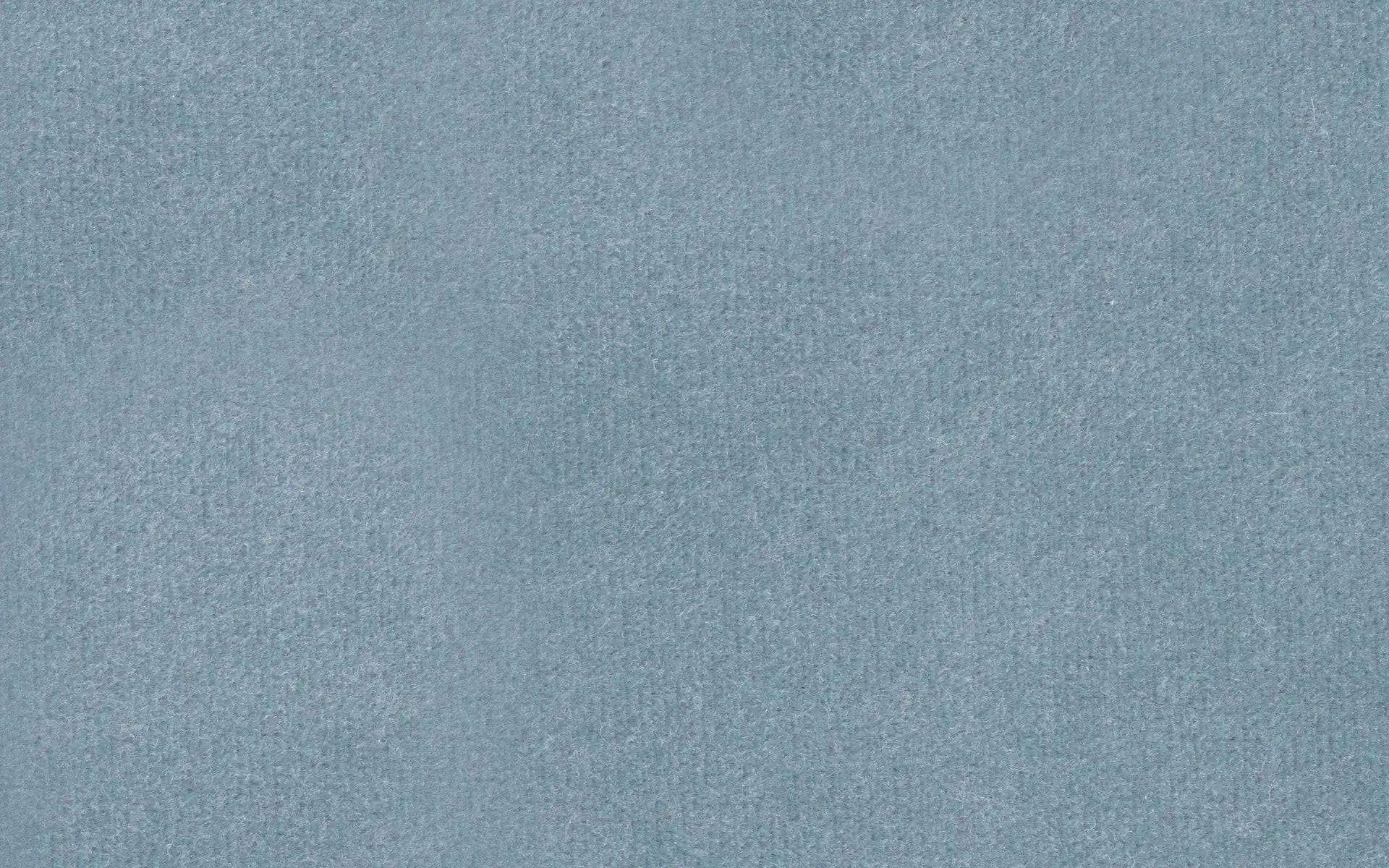 Close-up of a soft fabric swatch in muted blue-gray with a smooth, slightly fuzzy texture.