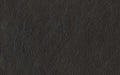 Close-up of black textured leather material with natural wrinkles and grain pattern for upholstery or fashion use.