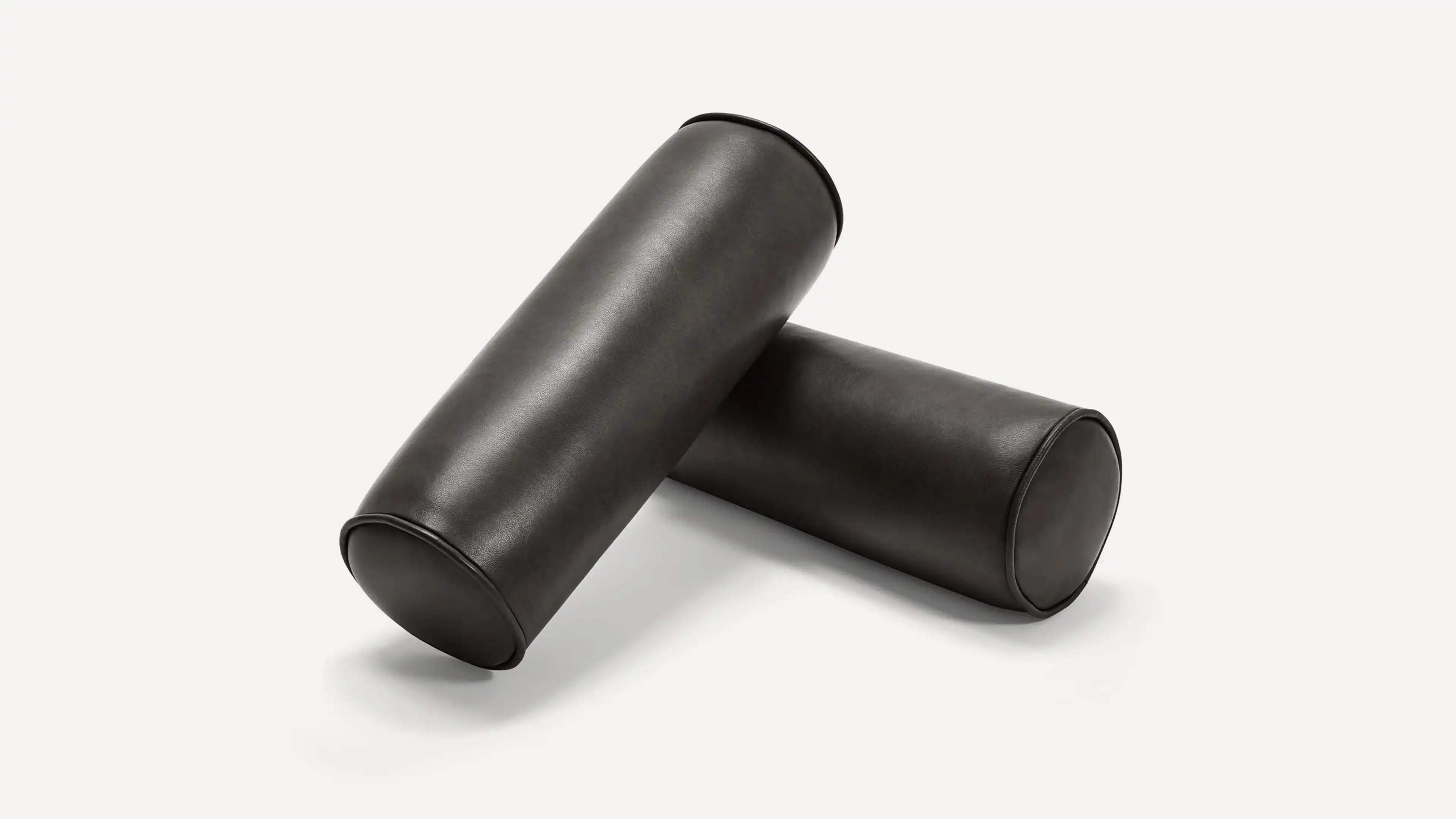 two black leather tube covers on a white background