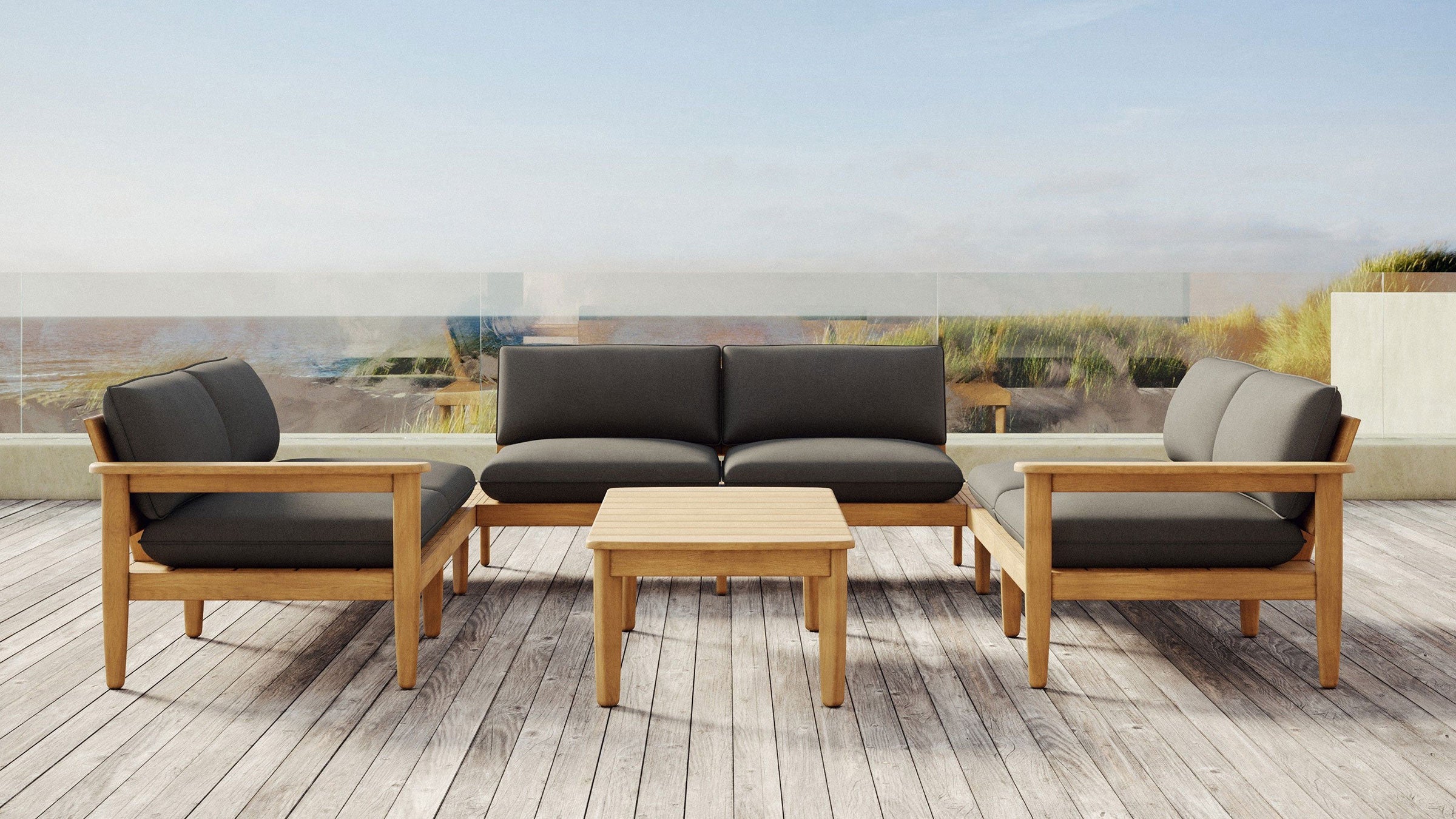 Outdoor patio furniture set with wooden frame and dark gray cushions, including two armchairs, a loveseat, and a small rectangular coffee table.