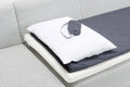 a white pillow on a gray couch