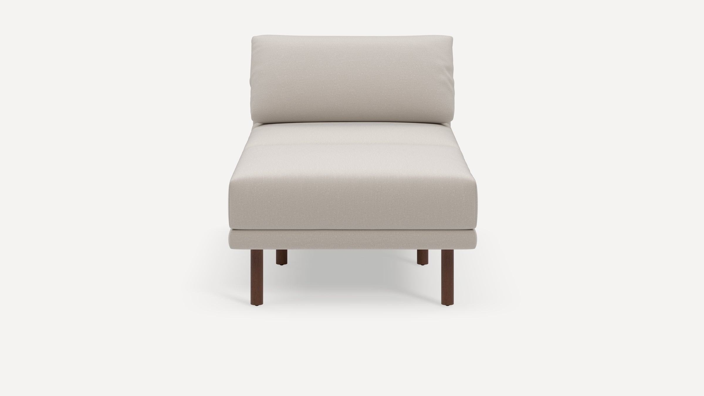 Beige cushioned chaise lounge with a simple, modern design and four dark wooden legs on a plain white background.