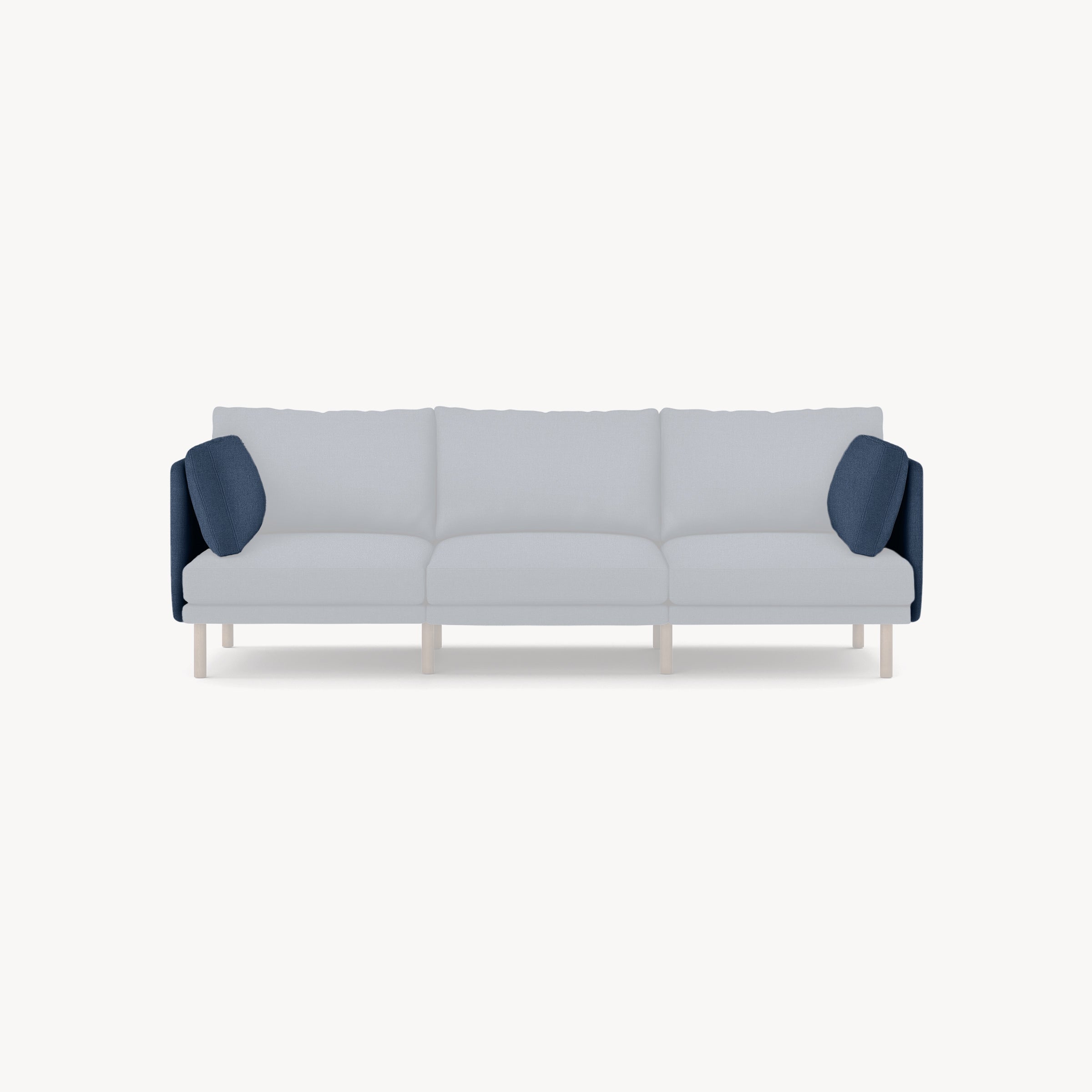 Modern three-seater sofa with light gray cushions and dark blue armrest pillows on light wooden legs, minimalist design.