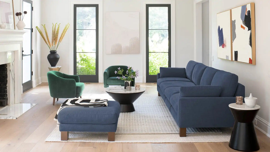 modern living room with blue sofas, green chairs, and a white rug