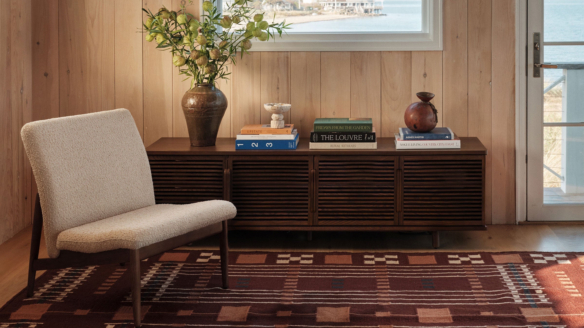 a living room with a wooden wall and a large window