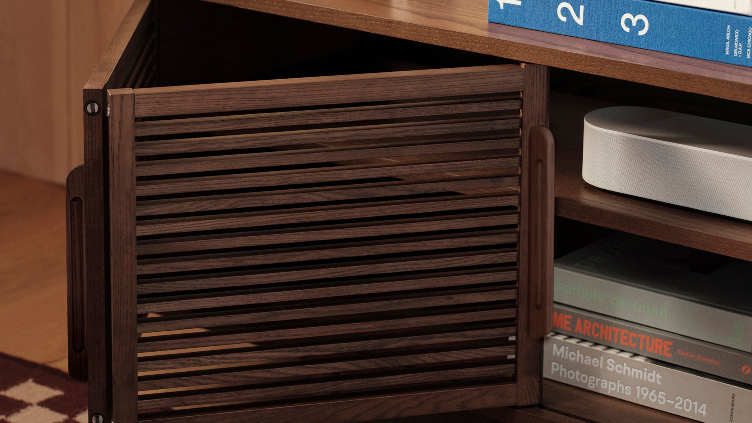 a wooden cabinet with a book shelf and a computer on top