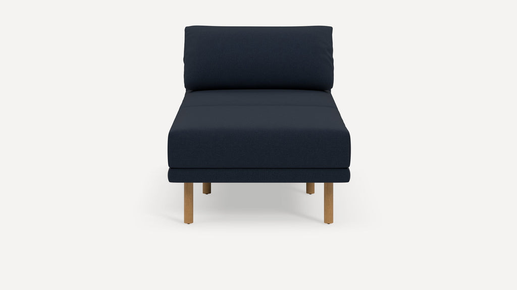 Front view of a modern navy blue cushioned chair with wooden legs against a plain white background.