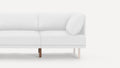 Modern white upholstered sectional sofa with clean lines, wooden legs, and a single matching cushion on the right side.