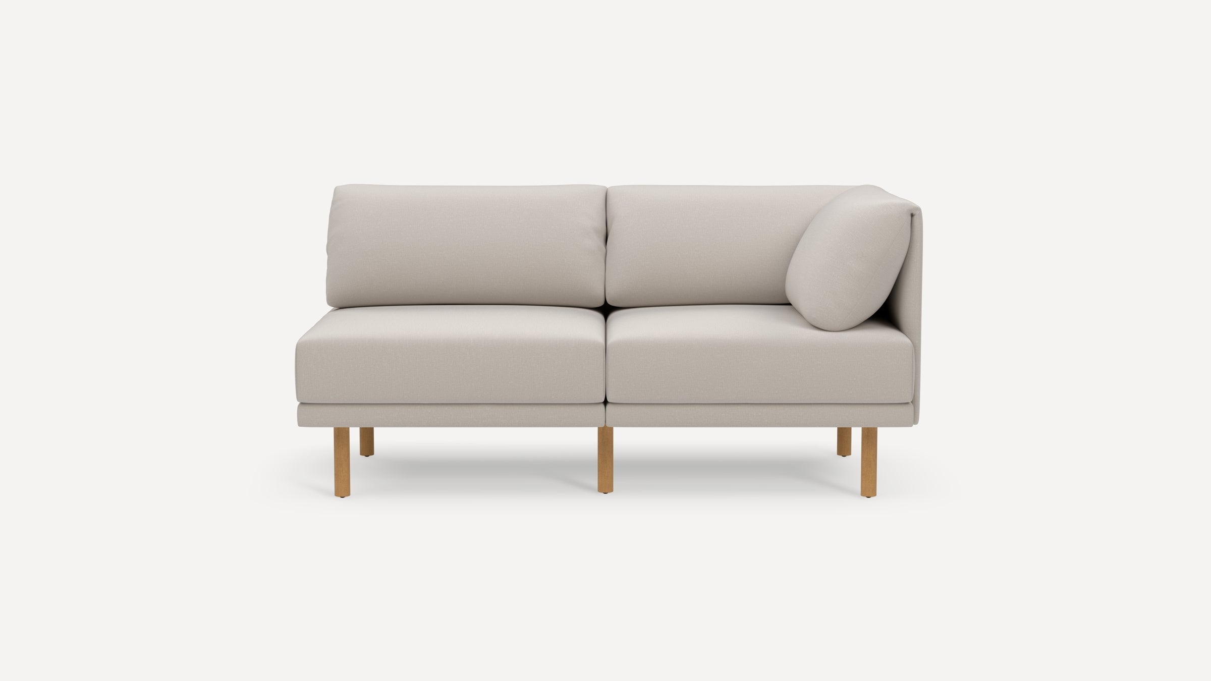 Modern light beige two-seater sofa with wooden legs and a corner backrest cushion on a plain white background.