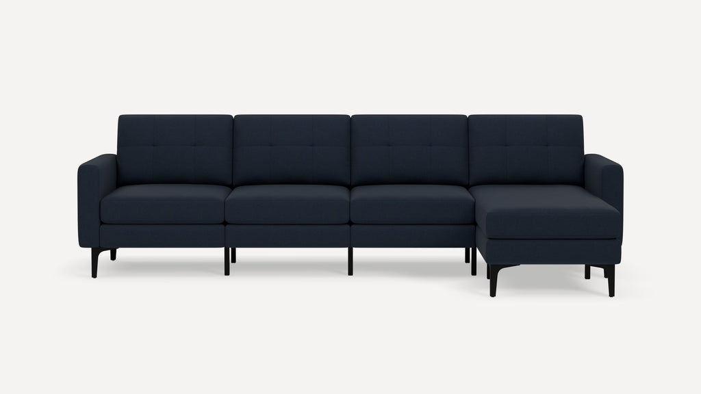 Modern dark blue sectional sofa with tufted back cushions, straight arms, and black legs against white background.