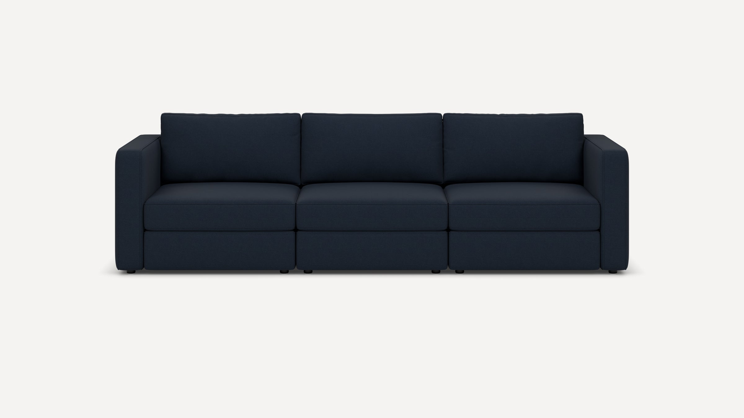 Modern navy blue fabric three-seater sofa with clean lines, boxy arms, and plush back cushions, set against a plain white background.