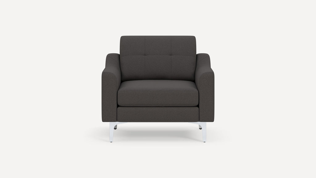 Dark gray upholstered armchair with tufted backrest, wide armrests, and sleek silver metal legs, shown against a white background.