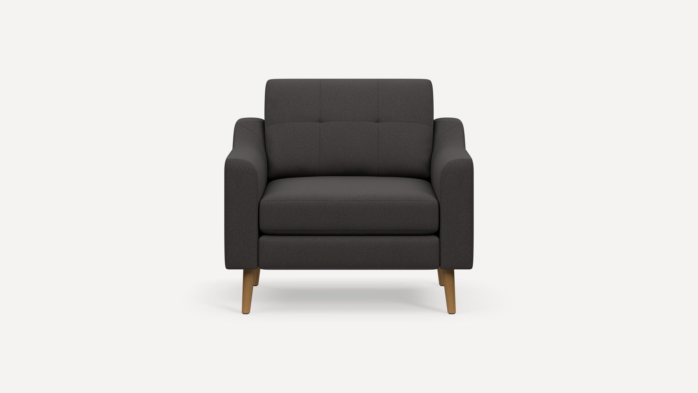 Dark gray upholstered armchair with tufted backrest, wide armrests, and light wooden tapered legs.