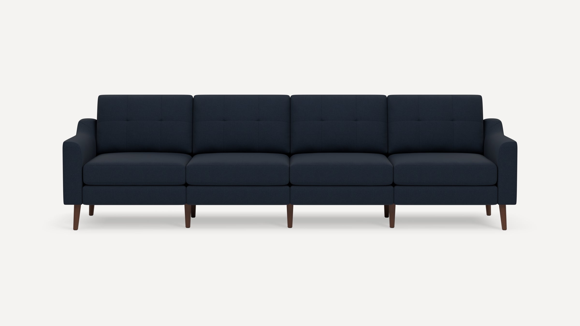 Modern four-seater navy blue fabric sofa with tufted back cushions and wooden tapered legs, set against a plain white background.