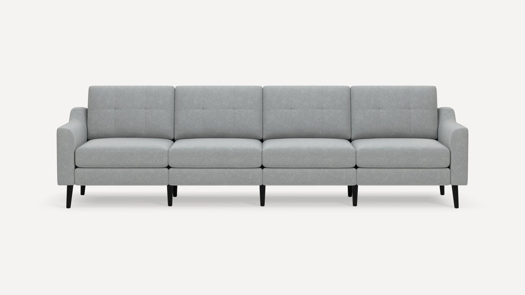 Light gray modern four-seater sofa with button-tufted back cushions and black tapered legs on a white background.