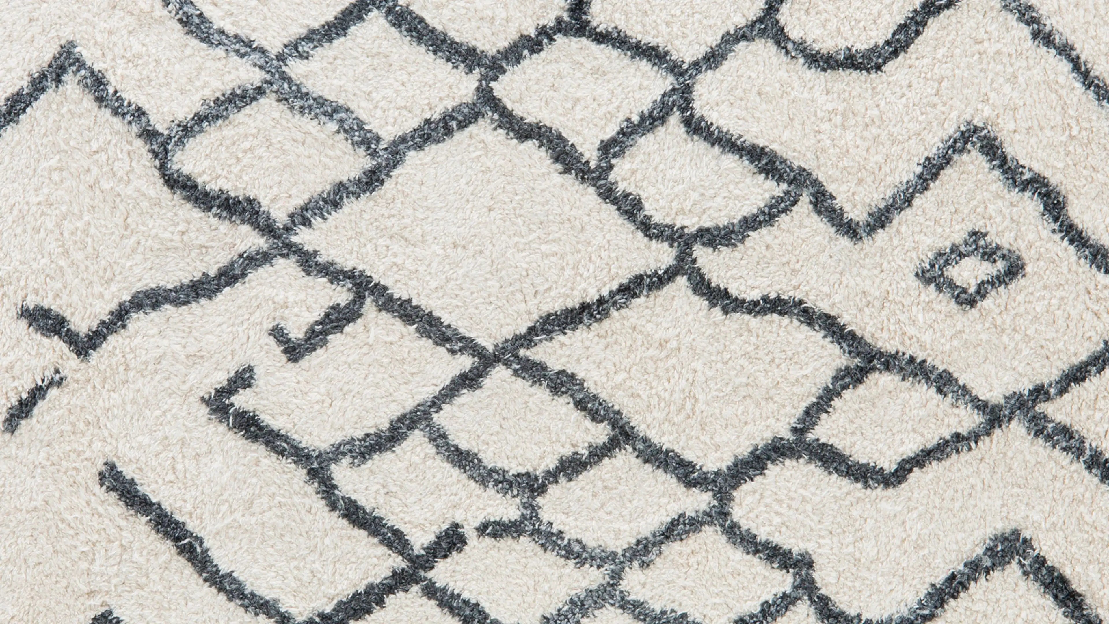a white rug with black and white geometric design