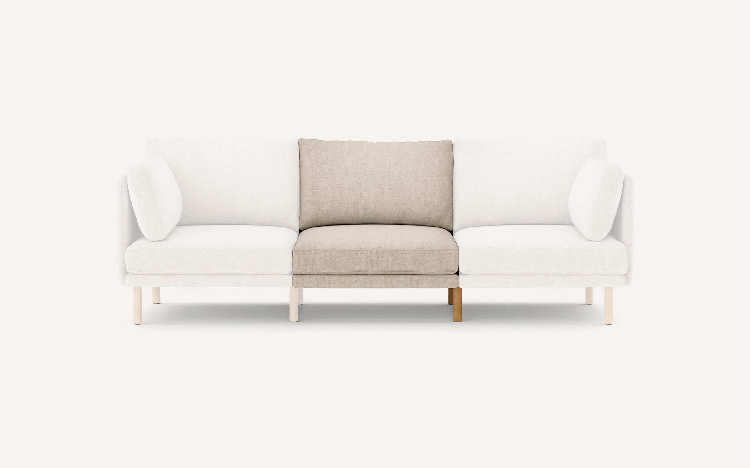 Modern three-seater sofa with white upholstery on outer seats and beige upholstery on the middle seat, featuring wooden legs.