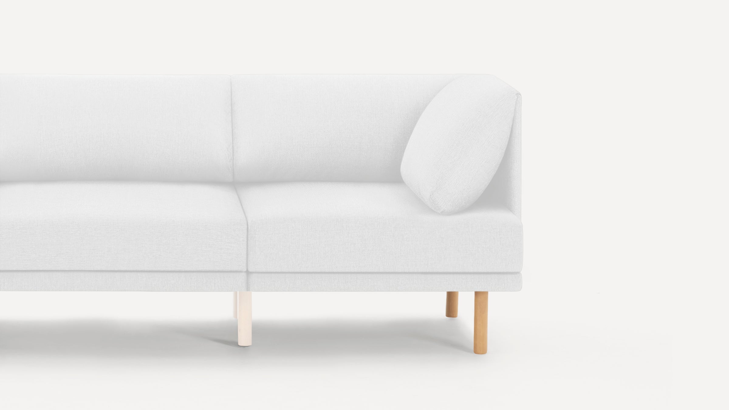 Modern white fabric sofa with wooden legs, featuring a clean, minimalist design and a cushioned armrest on one side.