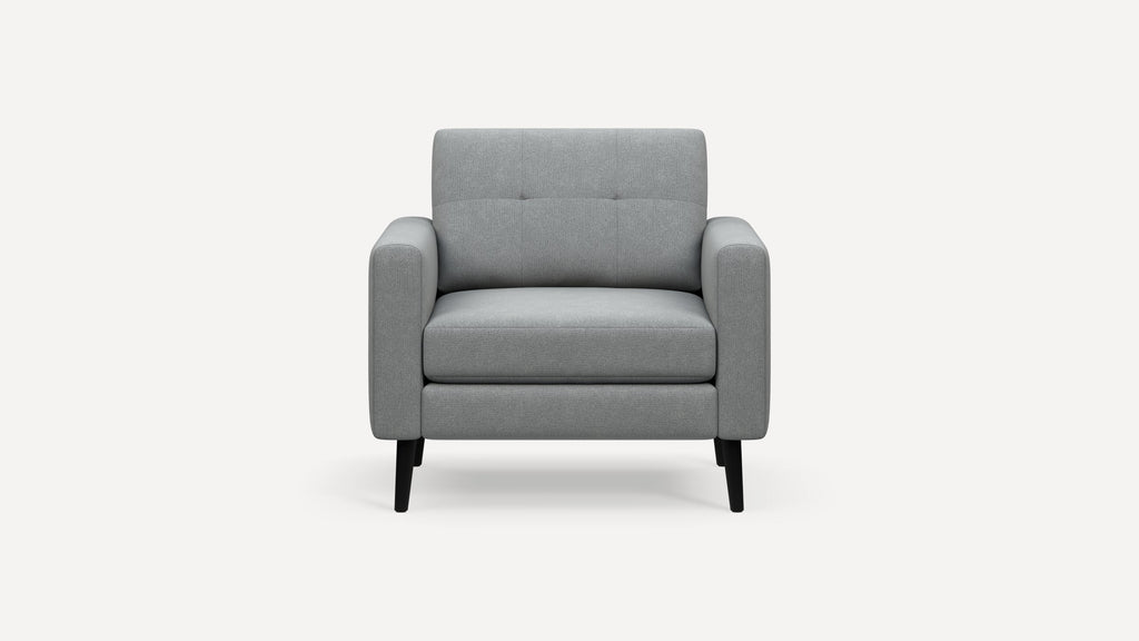 Front view of a modern gray upholstered armchair with wide padded arms and black tapered legs on a white background.