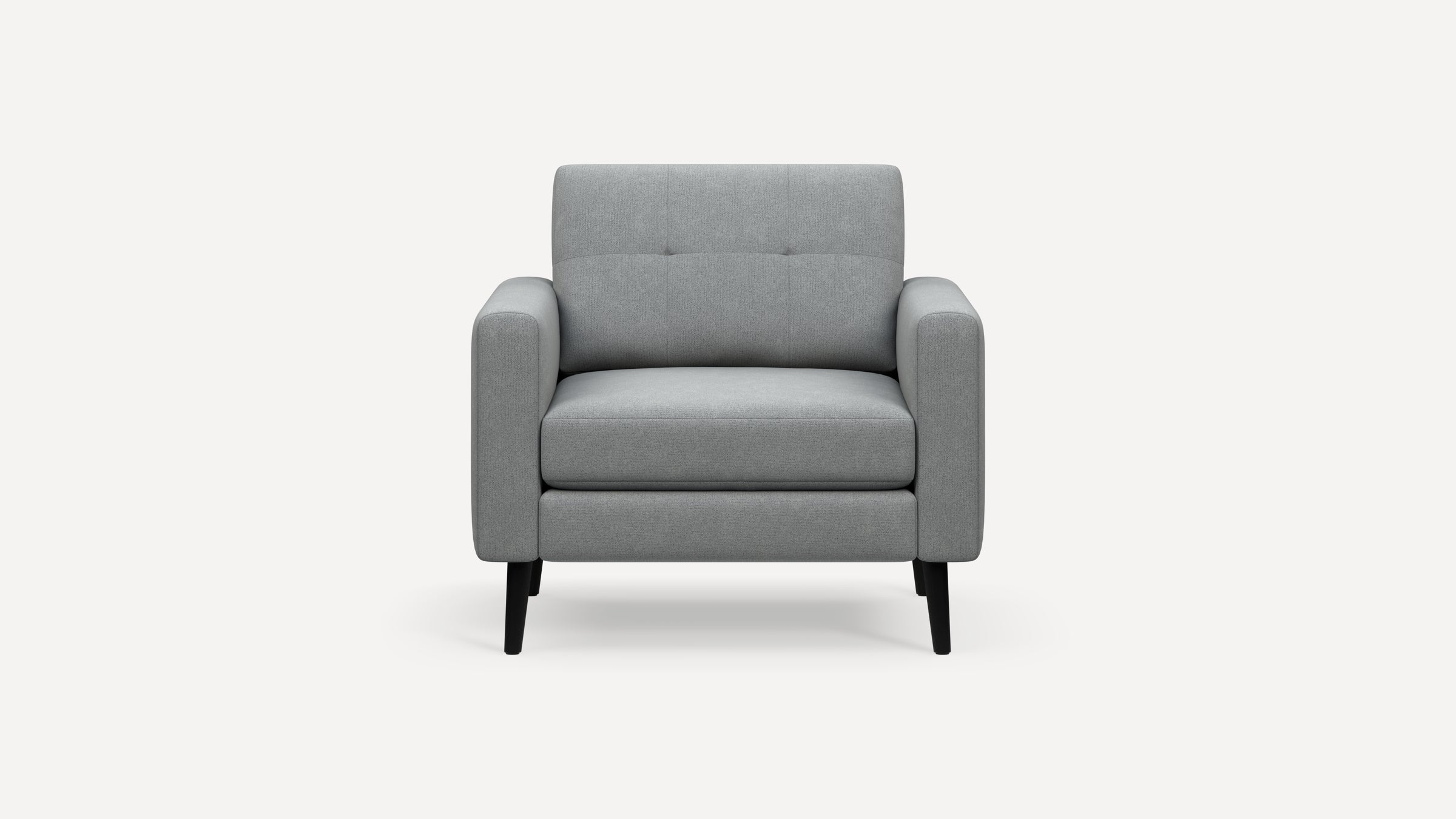 Front view of a modern gray upholstered armchair with wide padded arms and black tapered legs on a white background.