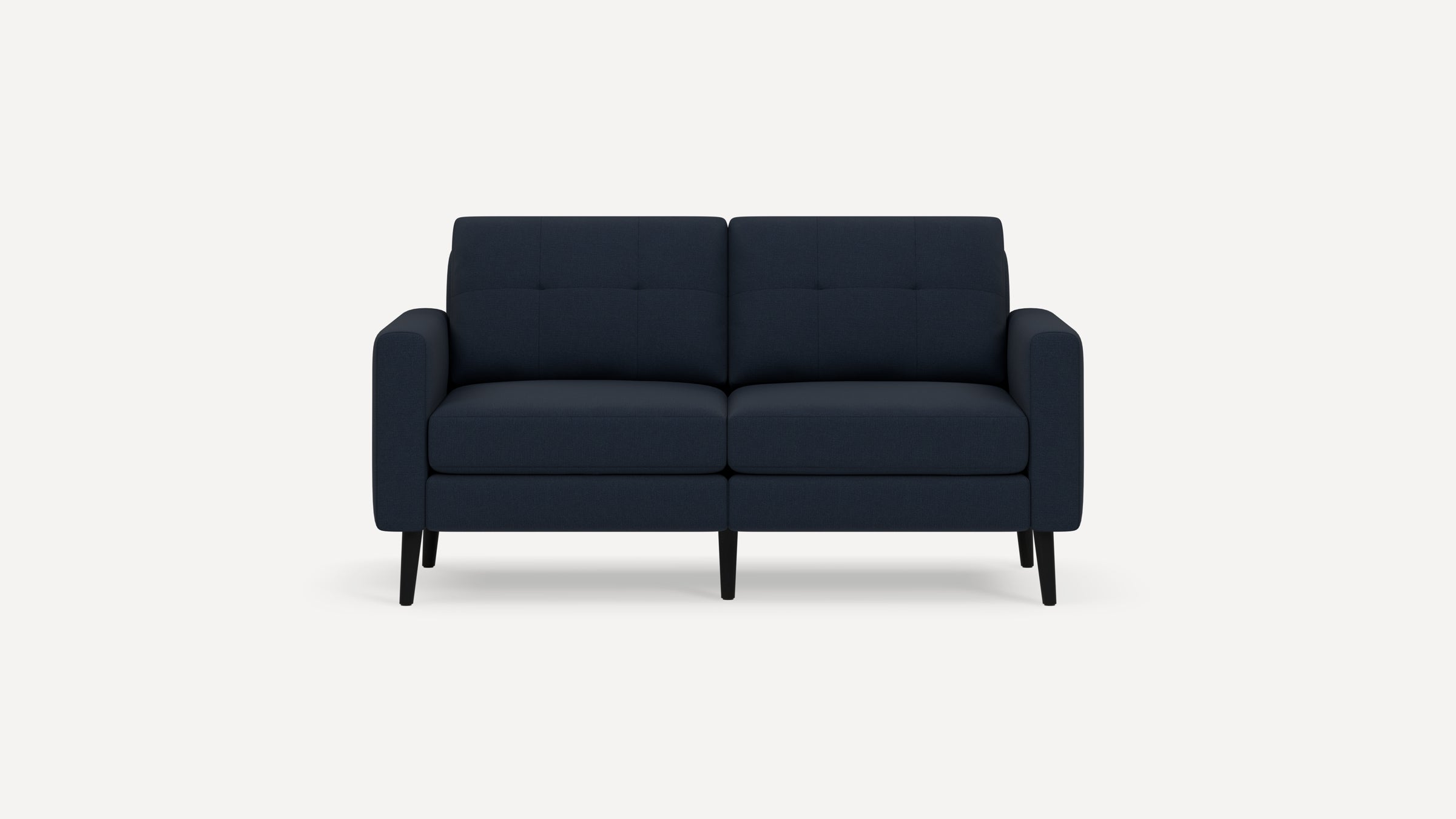 Modern two-seater sofa in dark blue fabric with tufted back cushions, rounded arms, and slim black wooden legs.