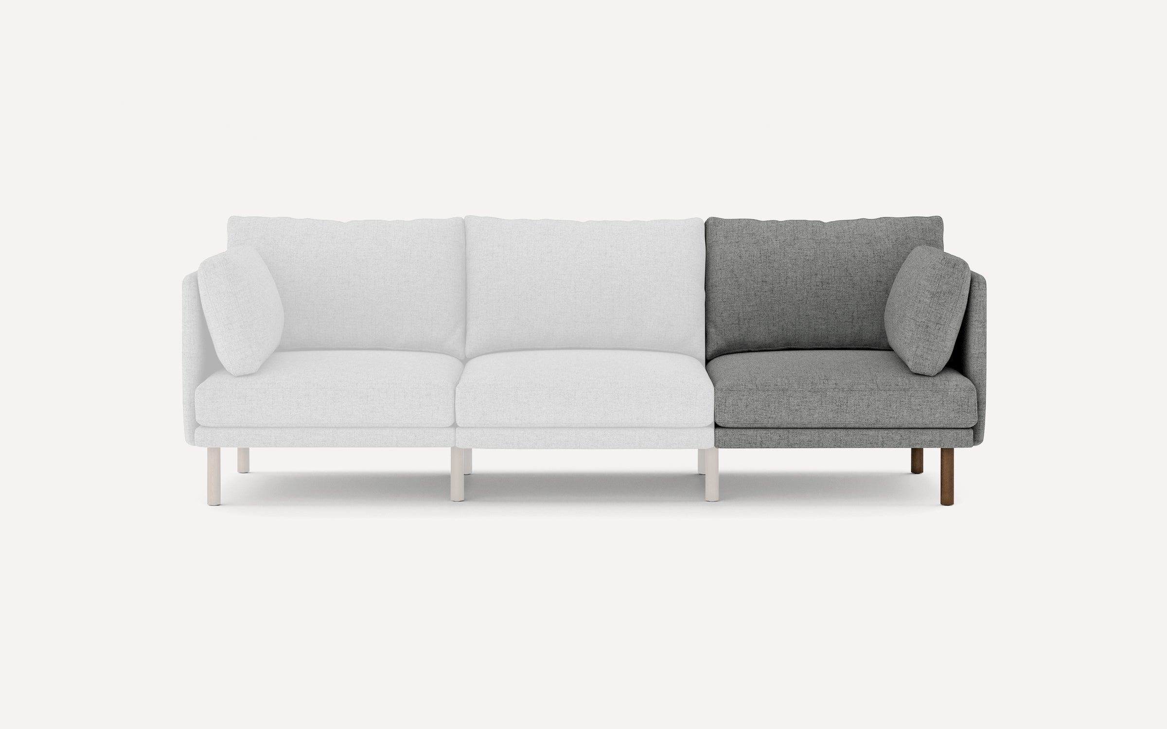 Modern sectional sofa with three seats; two sections in light gray fabric, one section in dark gray fabric with matching cushions.