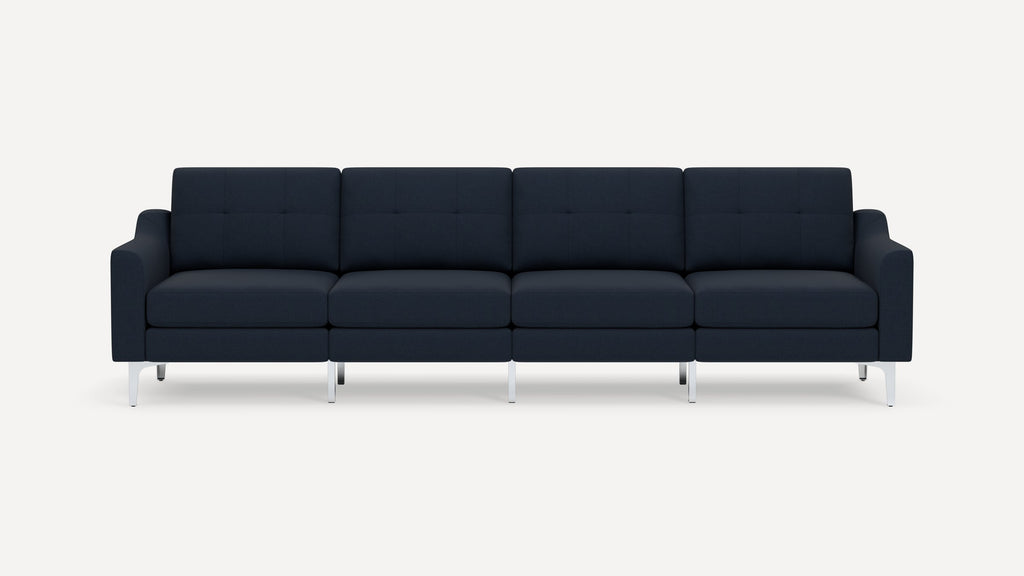 Modern four-seater navy blue sofa with cushioned seats and backs, square armrests, and sleek metal legs on white background.