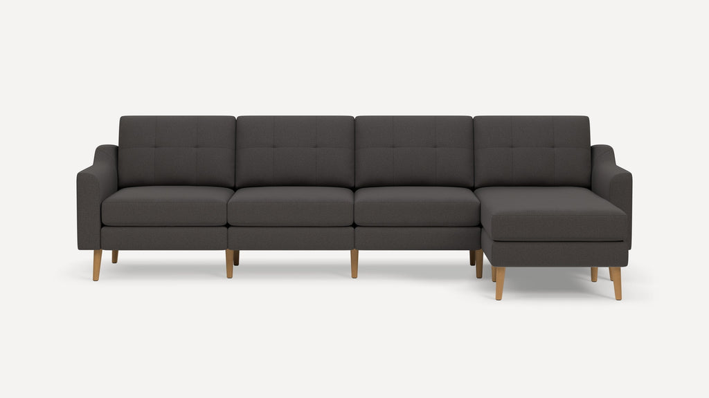 Modern dark gray sectional sofa with tufted cushions and wooden legs, featuring a right-side chaise lounge.