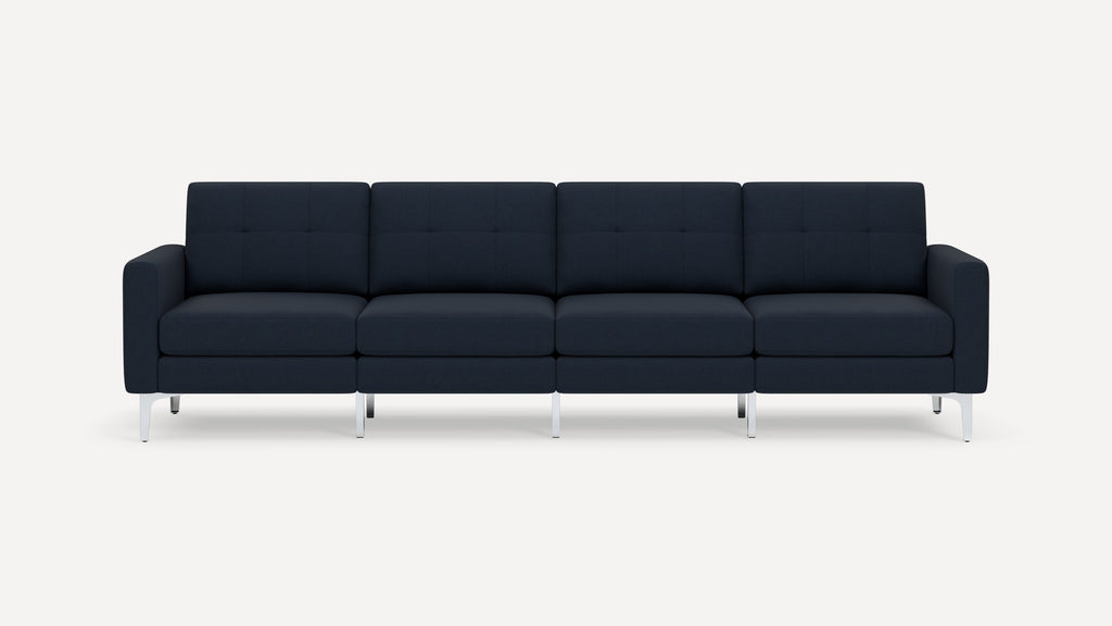 Modern navy blue four-seater sofa with clean lines, tufted cushions, and silver metal legs, set against a plain white background.