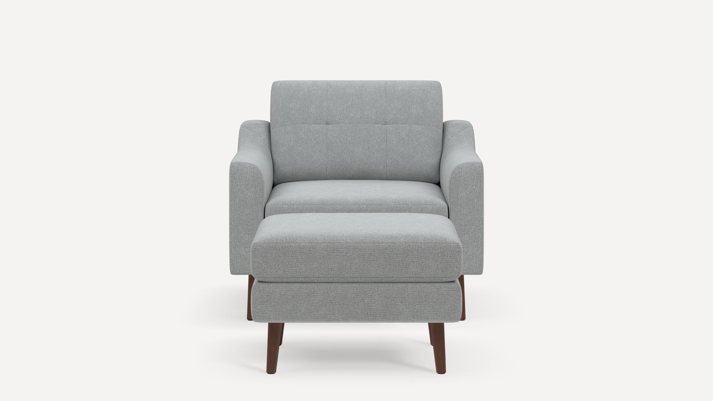 Front view of a modern light gray upholstered armchair with matching ottoman and wooden legs on a plain background.