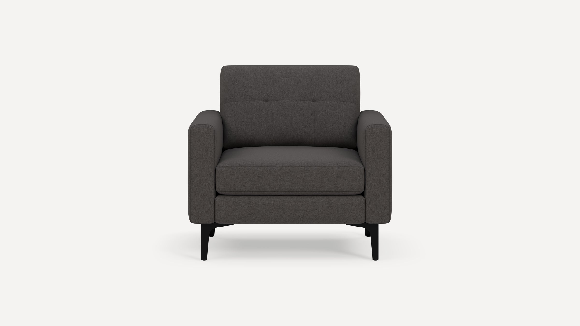 Dark gray upholstered armchair with tufted backrest and black slender legs, shown from the front on a plain white background.