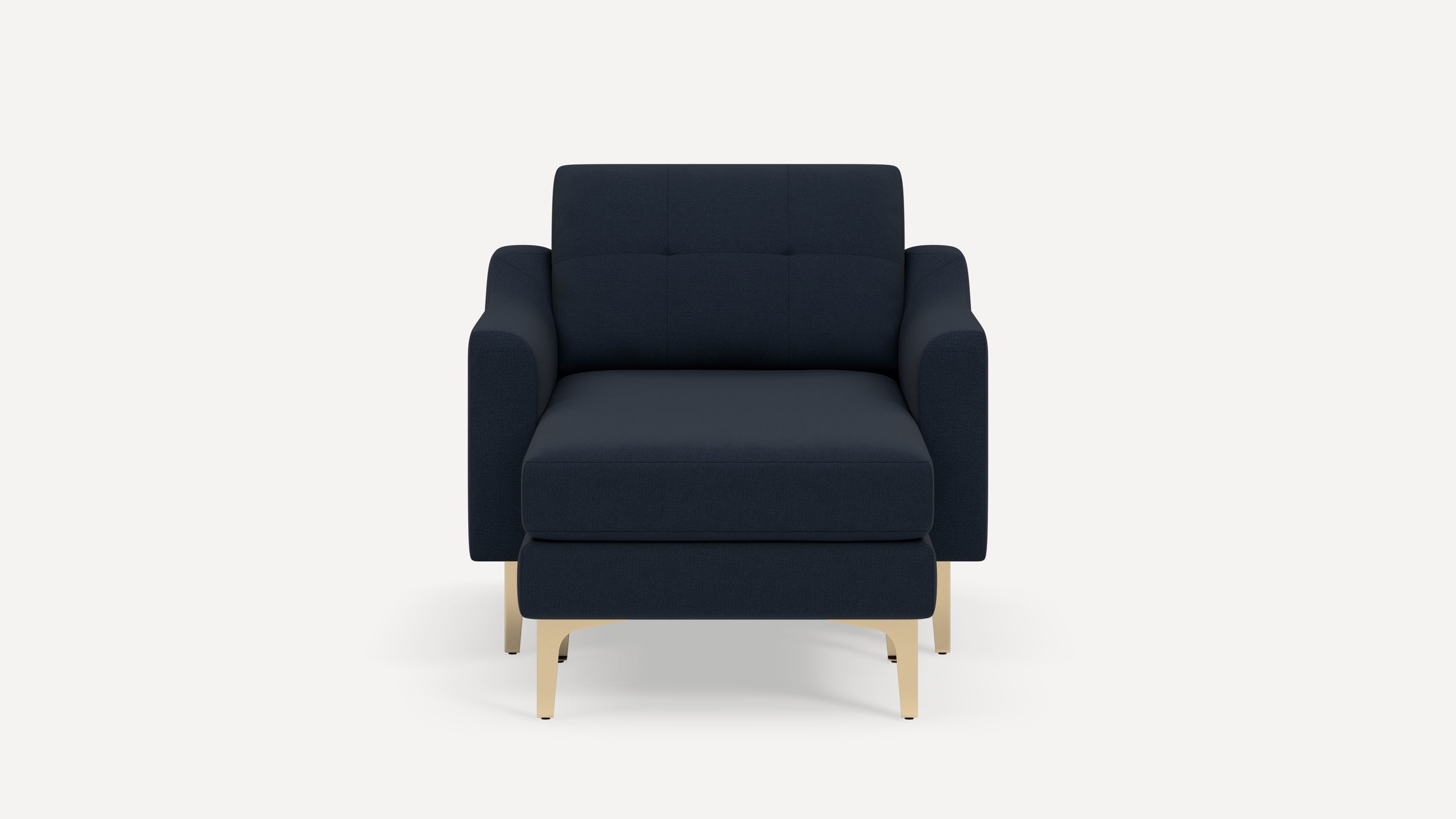 Front view of a modern navy blue armchair with a matching ottoman and light wooden legs on a white background.