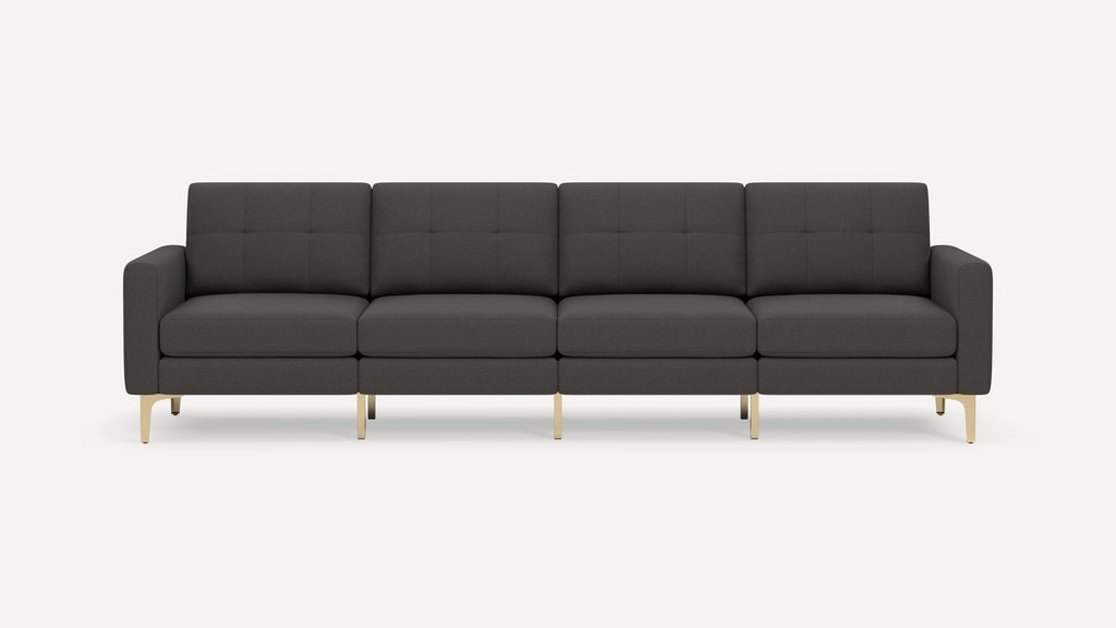 Modern dark gray four-seater sofa with tufted cushions and slim gold metal legs, set against a plain white background.
