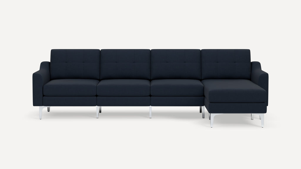 Modern navy blue sectional sofa with tufted cushions, metal legs, and right-side chaise lounge on white background.