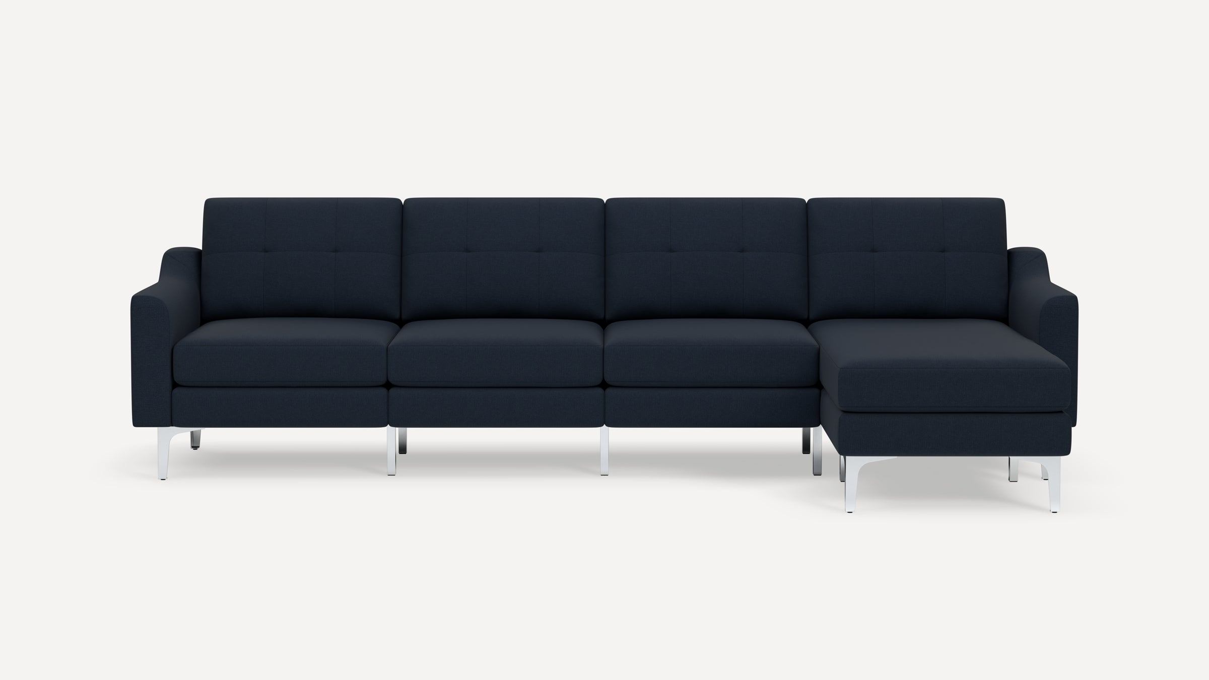 Modern navy blue sectional sofa with tufted cushions, metal legs, and right-side chaise lounge on white background.