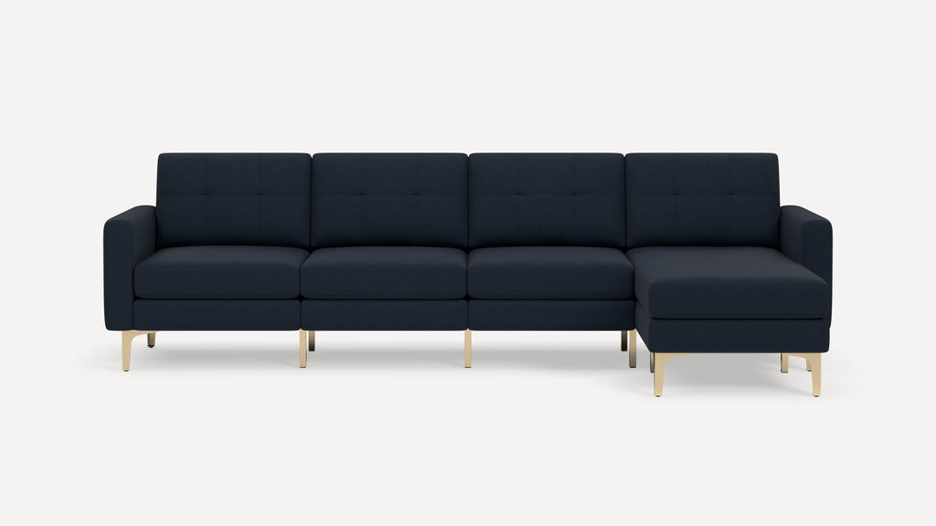 Modern navy blue sectional sofa with tufted cushions and gold metal legs, featuring a right-side chaise lounge.