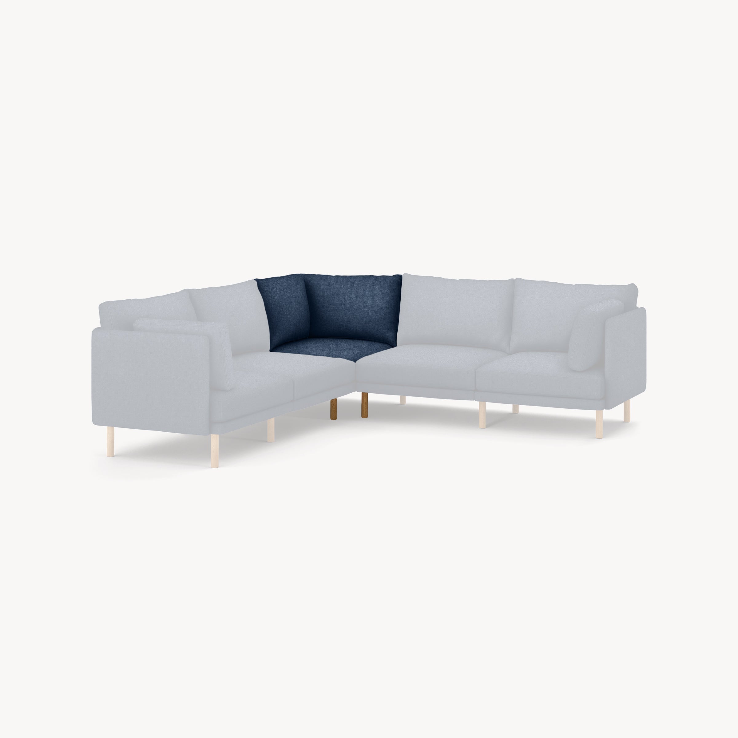 Modern L-shaped sectional sofa with light gray cushions and a single dark blue corner cushion, supported by thin wooden legs.