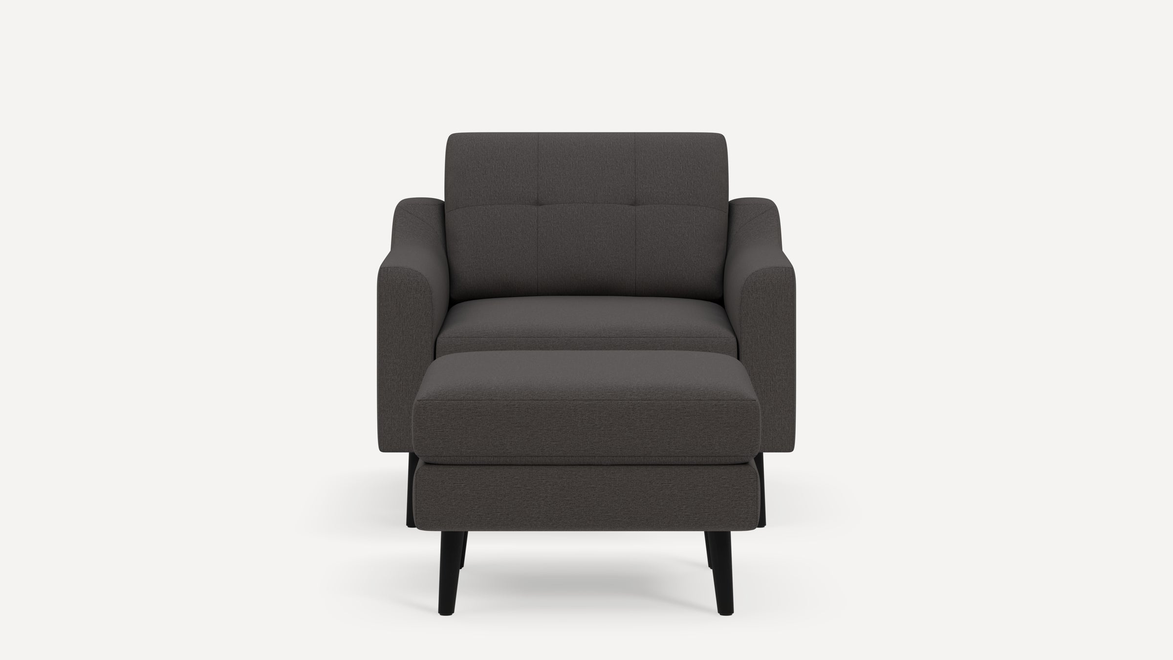 Front view of a modern dark gray upholstered armchair with a matching cushioned ottoman and black wooden legs.