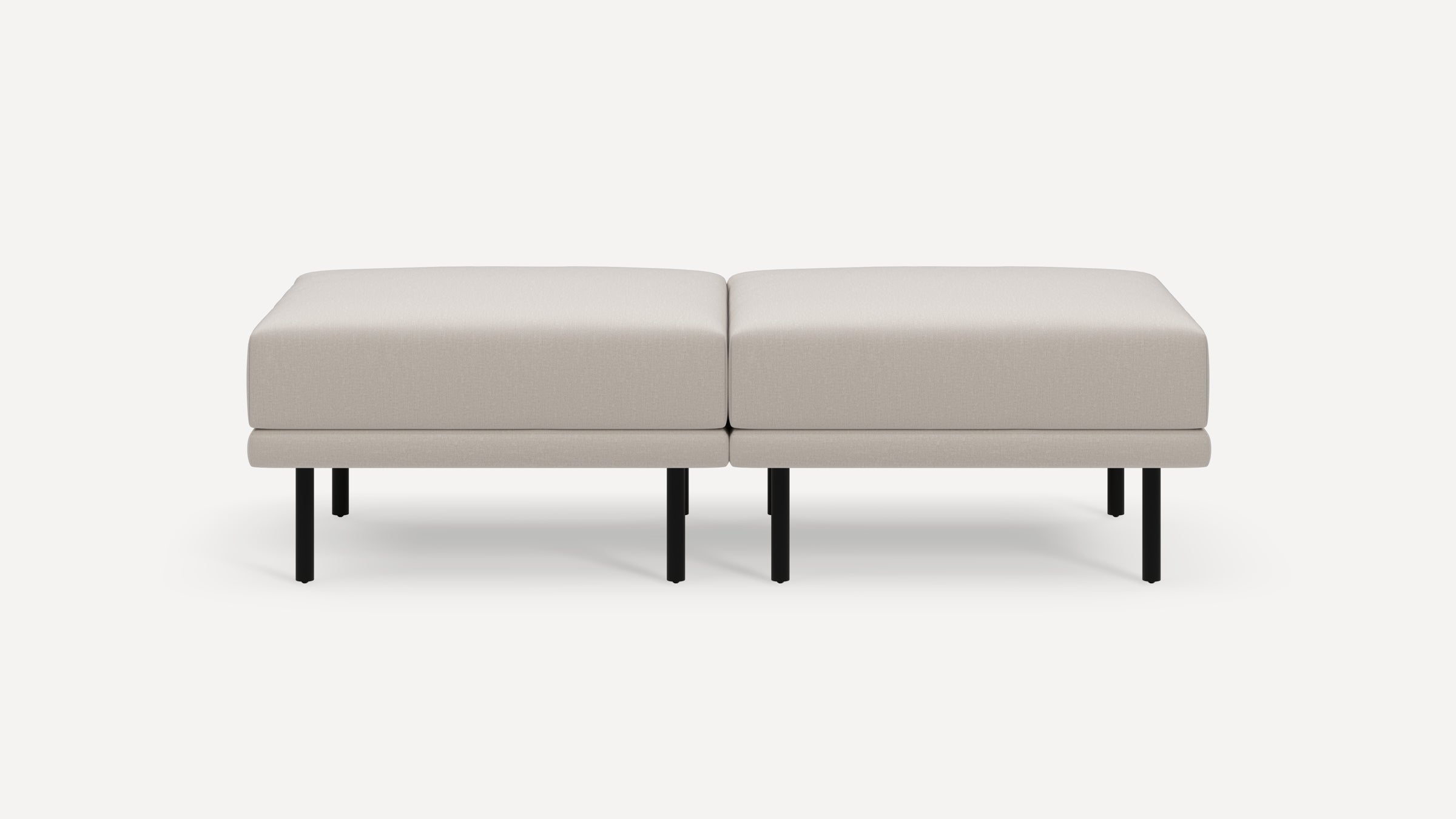 Modern beige upholstered bench with clean lines, two cushions, and black metal legs on a white background.