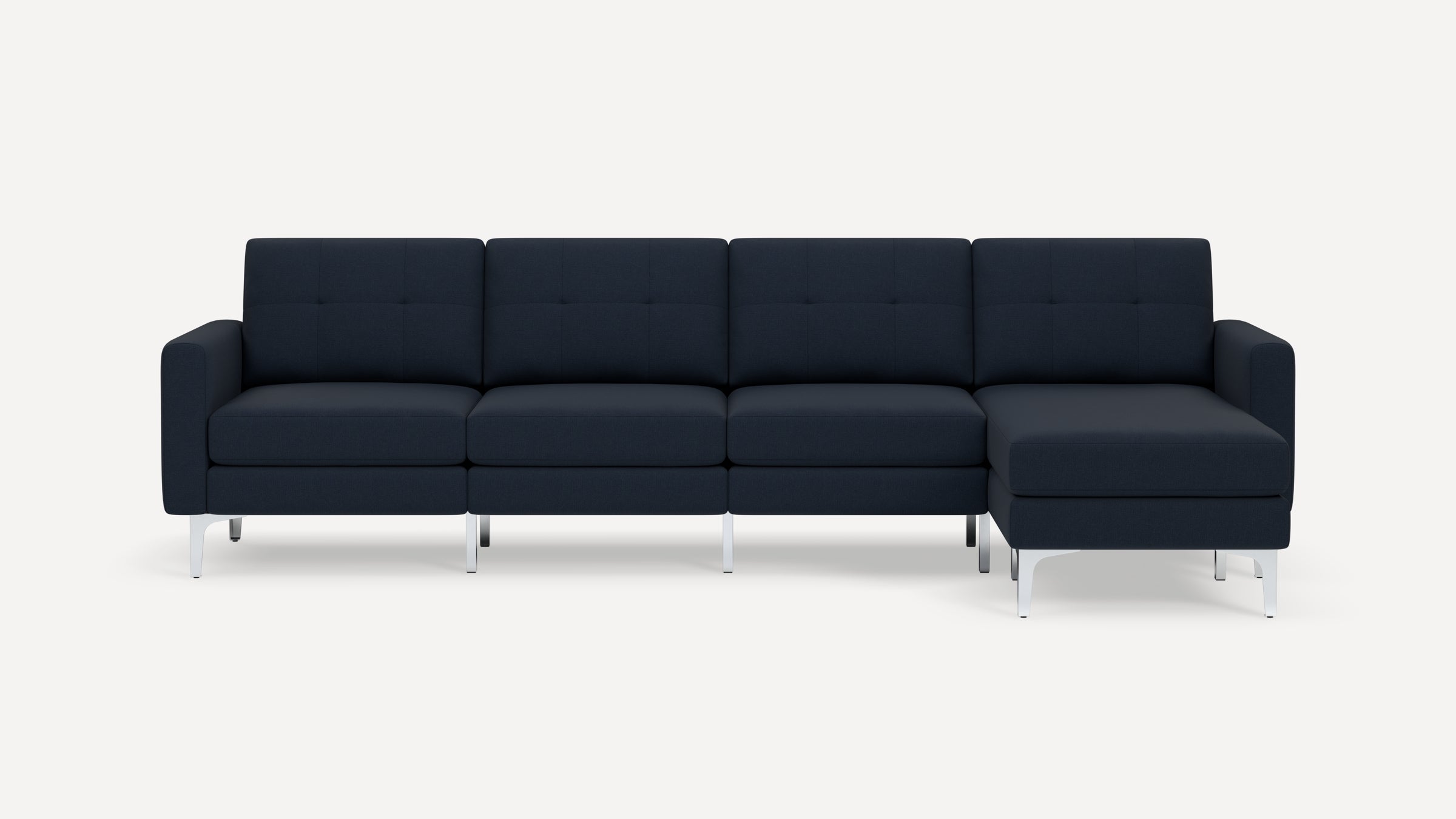 Modern dark blue sectional sofa with tufted back cushions, straight arms, and silver metal legs on white background.