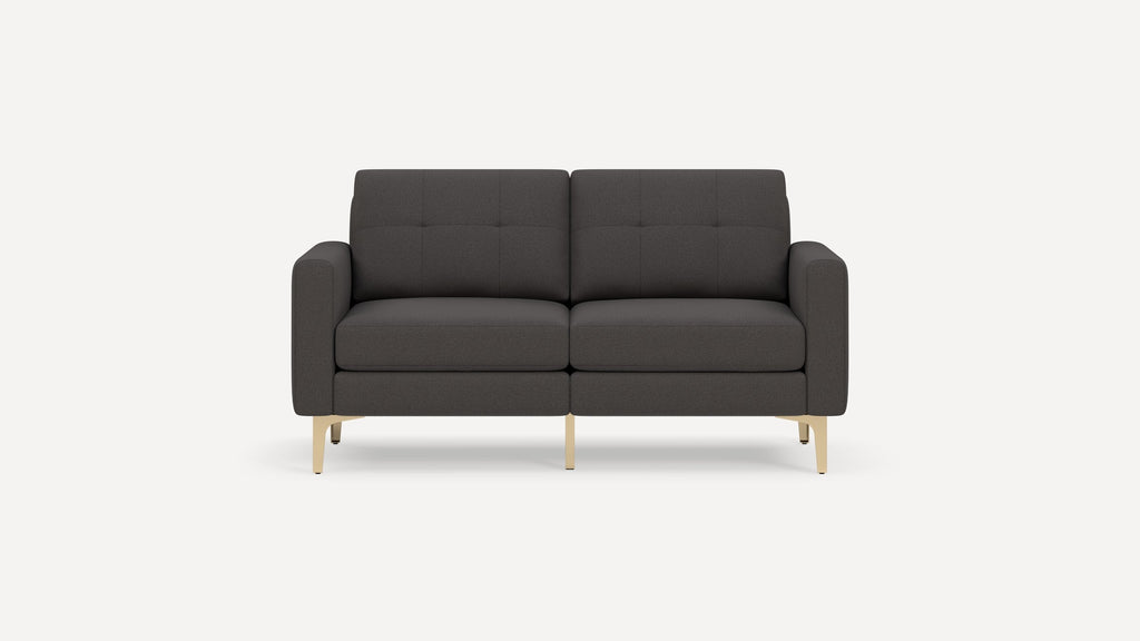 Modern dark gray two-seater sofa with tufted back cushions, clean lines, rounded arms, and gold metal legs on a white background.
