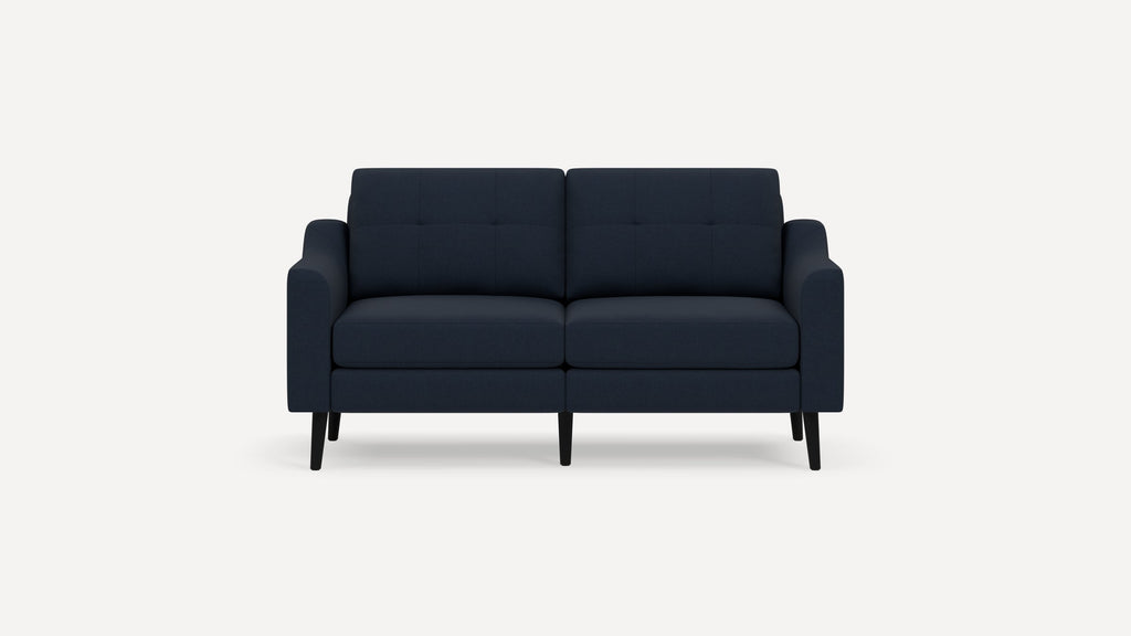 Modern navy blue fabric two-seater sofa with tufted backrests and black tapered legs on a white background.