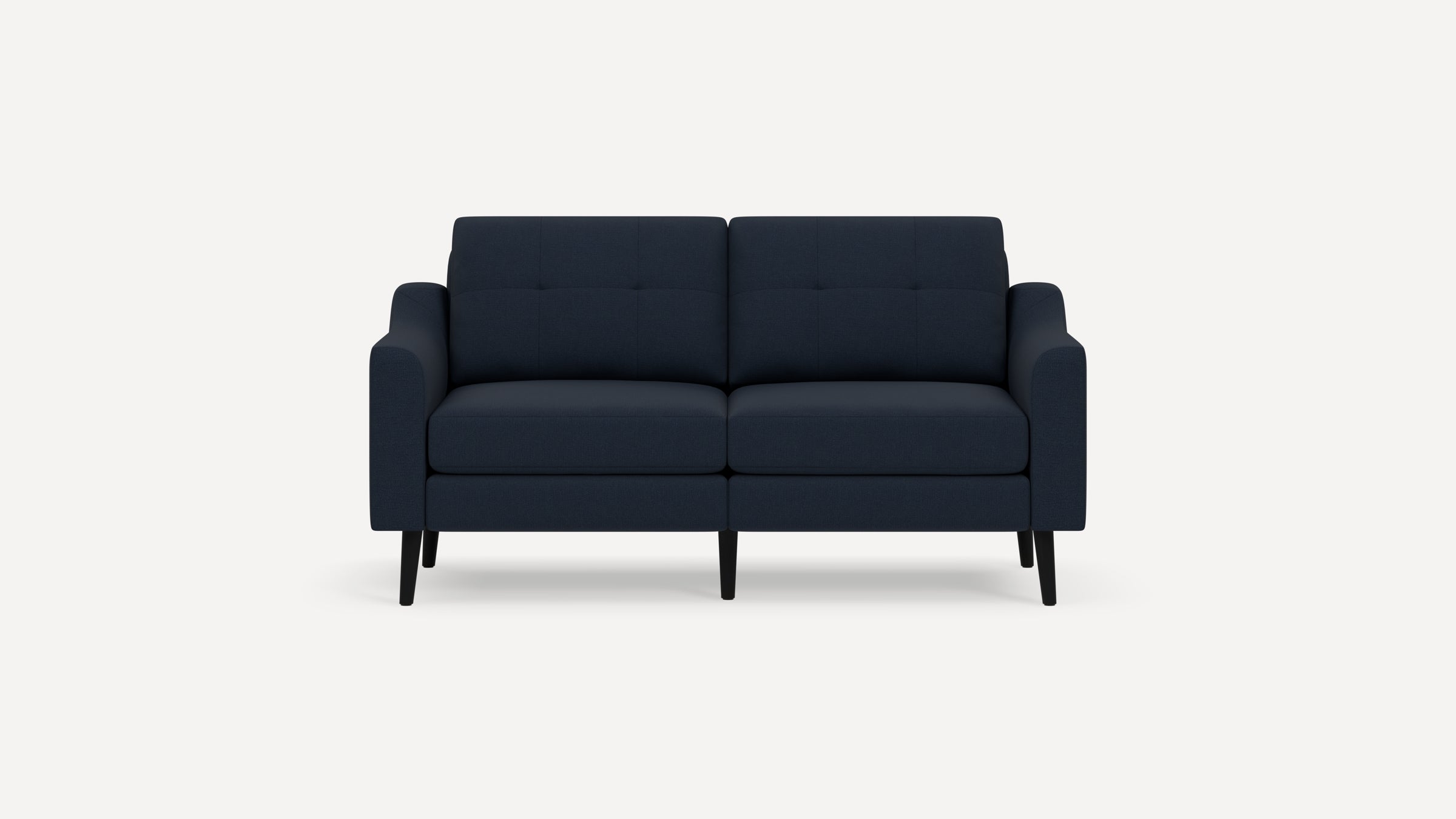 Modern navy blue fabric two-seater sofa with tufted backrests and black tapered legs on a white background.