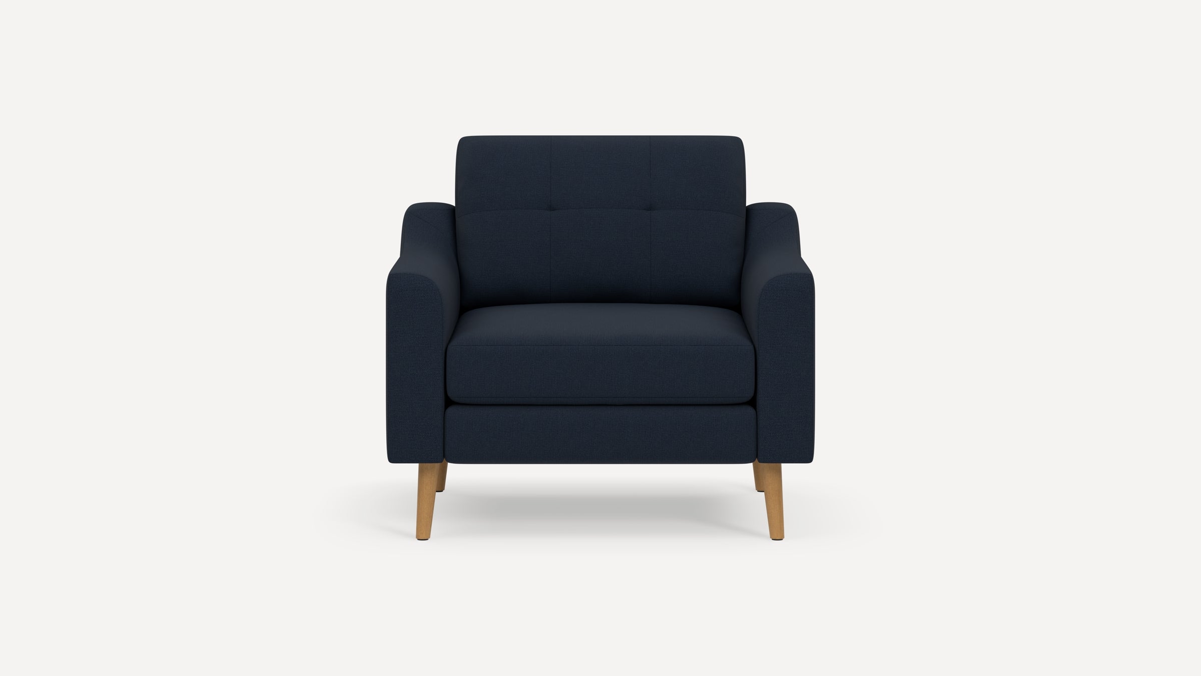 Modern navy blue upholstered armchair with wooden legs and tufted backrest, shown against plain white background.