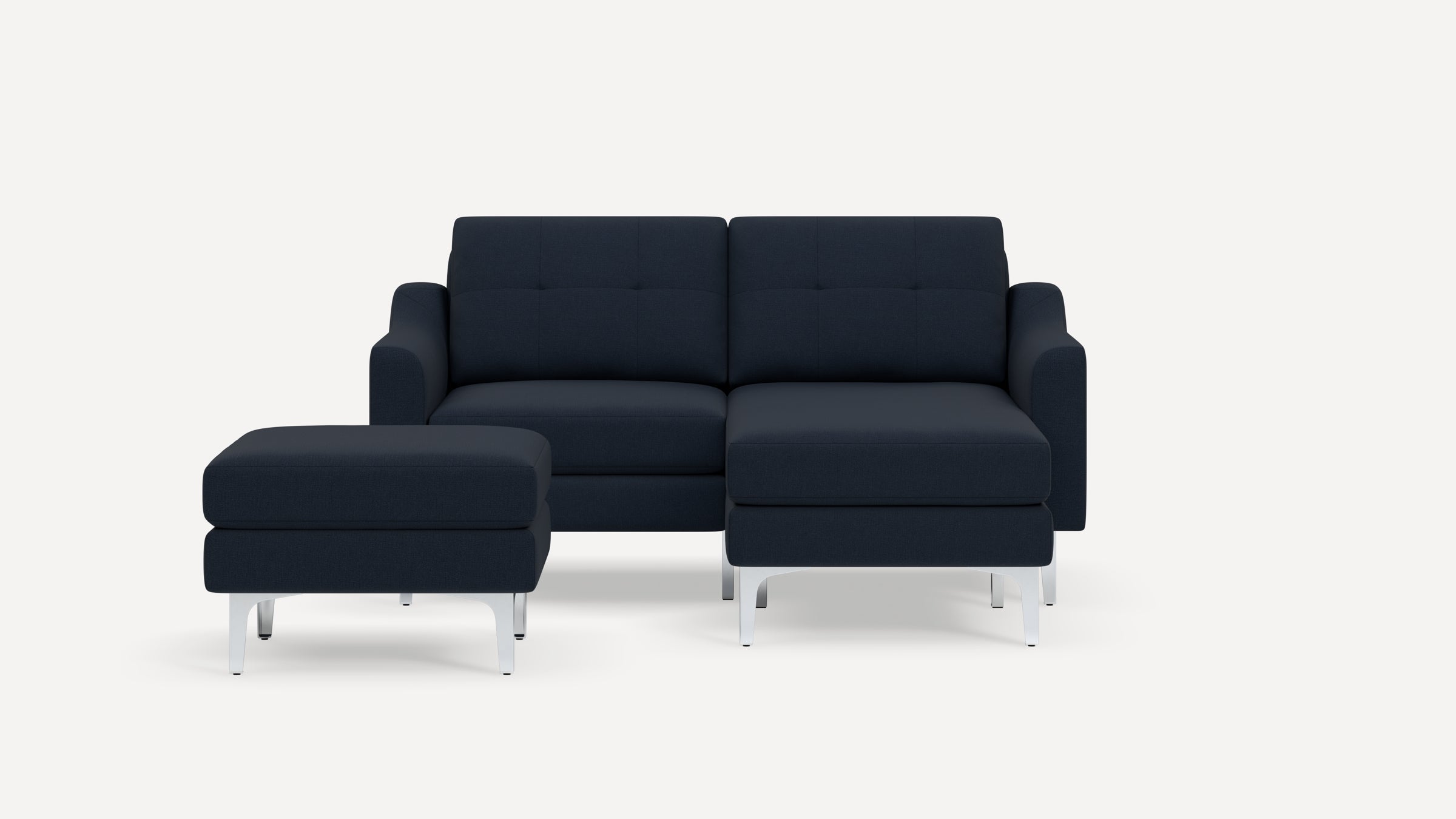 Modern navy blue two-seater sofa with matching ottoman, both featuring metallic legs and tufted cushions.